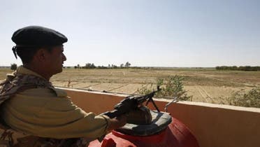 An Iraqi border policeman mans a machine gun near the Iraqi-Syrian borders at the Albu Kamal-Qaim border crossing, the main border post between Iraq and Syria. (Reuters)