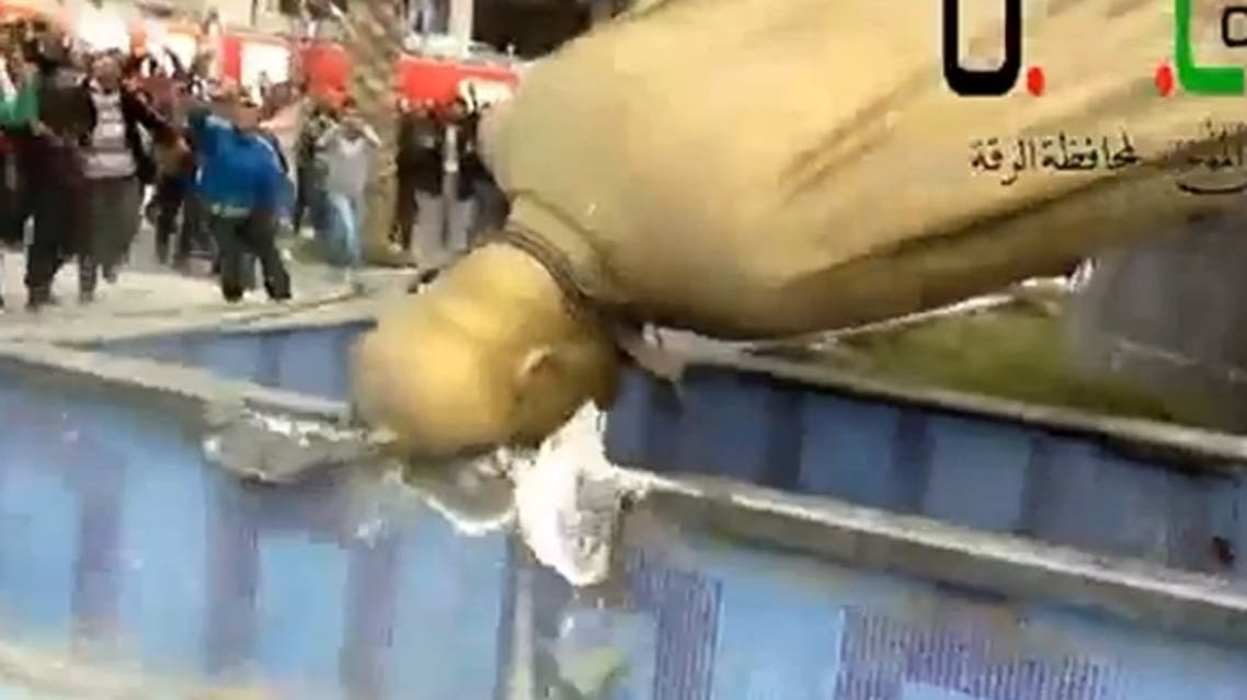 The statue of Hafez al-Assad was brought down by Syrian rebels after they overrun the town of Reqqa. (Video grab from YouTube video)