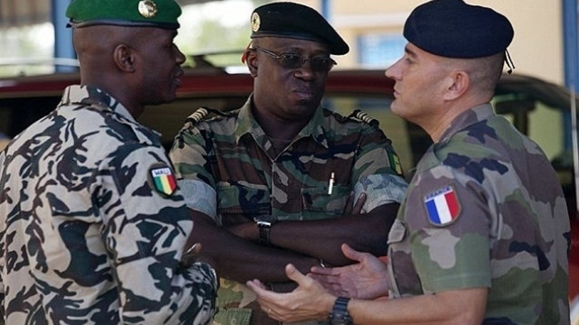 A French army officer, right, talks to his Malian and Senegalese army counterparts outside where a meeting is taking place for the intervention force provided by the ECOWAS grouping of West African states, in Bamako. (Reuters)