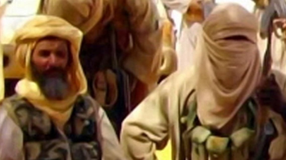 This Al-Andalus image grab taken on September 30, 2010 from a video released today shows Abu Zeid (L), also known as Abid Hammadou, posing with fighters of al-Qaeda in the Islamic Maghreb (AQIM) and hostages (unseen) seized two weeks ago, among whom are five French. (AFP)