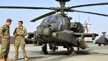 Britain’s Prince Harry is shown the Apache helicopter flight line by an unidentified member of his squadron at Camp Bastion, Afghanistan. Six U.S. fighter jets were destroyed at Camp Bastion by the Taliban on Friday, NATO said. (Reuters)