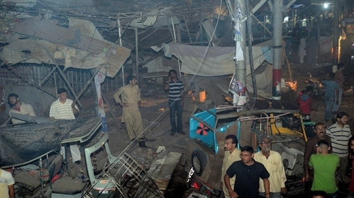 Pakistani rescuers work at the site of the bomb blast in Karachi on March 3, 2013. A bomb attack in Pakistan's largest city Karachi on Sunday killed at least 23 people, including women and children, and wounded 50 others, police said. (AFP)