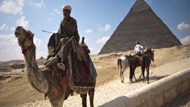 An Egyptian man waits for tourists to take them on camel rides at the Giza pyramids on the outskirts of Cairo. The country’s economy has taken a huge dip after foreign tourists fled during Egypt’s uprising. (AFP)