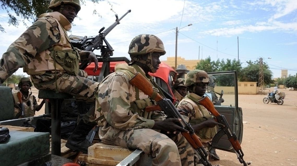 Soldiers guard a crossroads on February 12, 2013 in the center of the northern Malian city of Gao, where the militant group Movement for Oneness and Jihad in West Africa (MUJAO) had controlled the city since June.(AFP)