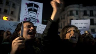 An Egyptian woman activist holds a knife while taking part in a protest for women against sexual harassment. (Photo courtesy of AP)