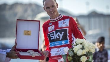 Britain’s cyclist of Sky Procycling Team Christopher Froome poses on the podium after receiving the leader’s red jersey at the end of the sixth and last stage of the cycling Tour of Oman, on February 16, 2013, in the Omani capital Muscat. (AFP)