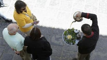 A waiter serves mint tea to tourists in the medina, the old city of Tunis April 21, 2012. (Reuters)