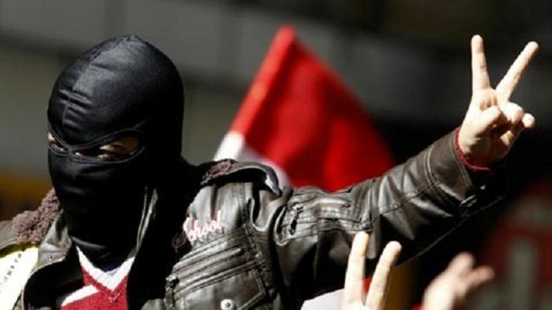 A member of the Black Bloc, who opposes Egyptian President Mohamed Mursi, gestures and shouts slogans during a protest against Mursi and members of the Muslim Brotherhood at Tahrir Square in Cairo Feb. 15, 2013. (Reuters)