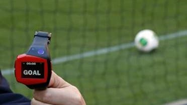 A FIFA official holds a wrist watch used as part of the Hawk-Eye goal-line technology. (Reuters)