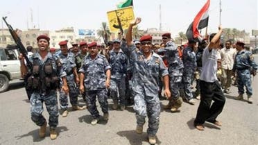 police and soldiers celebrate in the southern city of Basra on Tuesday after U.S. troops withdrew from towns and cities across the country.