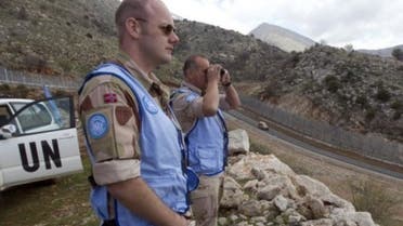 United Nations soldiers look along the ceasefire line between the Israeli-occupied Golan Heights and Syria, in the Druze village of Majdal Shams. (AFP)