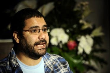 Egyptian blogger and activist Alaa Abdel Fattah speaks during a TV interview at his house in Cairo. (AFP)