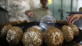 Gaza cook uses own hands to extract falafel from boiling oil 