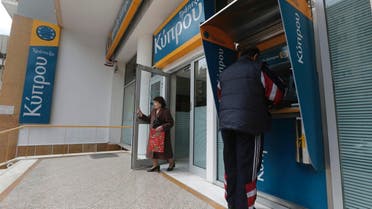 A woman leaves a Bank of Cyprus branch in Athens March 27, 2013. Cyprus confirmed banks would reopen on Thursday after a nearly two-week lockdown on the bailed-out country. (Reuters)