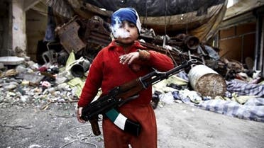 7 year old Syrian rebel poses with AK47