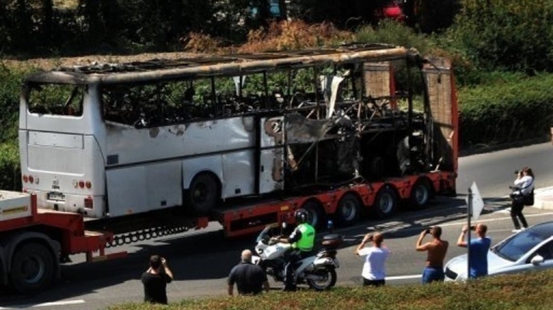 A truck carries the bus that was damaged in a bomb blast in the Black Sea city of Burgas that killed the Israelis and their Bulgarian driver, on July 19, 2012. (AFP)