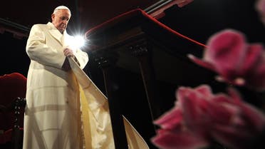 Pope Francis puts his coat on during the celebration of the Good Friday at the Colosseum in Rome. (AFP)