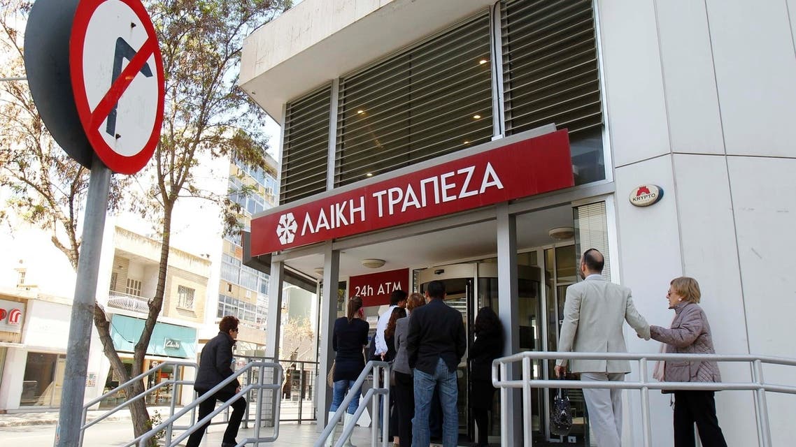 Depositors wait to enter a branch of Laiki Bank in Nicosia. Cypriots hoped for relaxation of the first capital controls in the Eurozone after authorities dropped domestic restrictions on credit card payments. (Reuters)