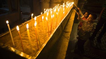 Young worshippers light candles during Easter Sunday mass at the Church of the Holy Sepulchre in Jerusalem's Old City March 31, 2013. (Reuters)