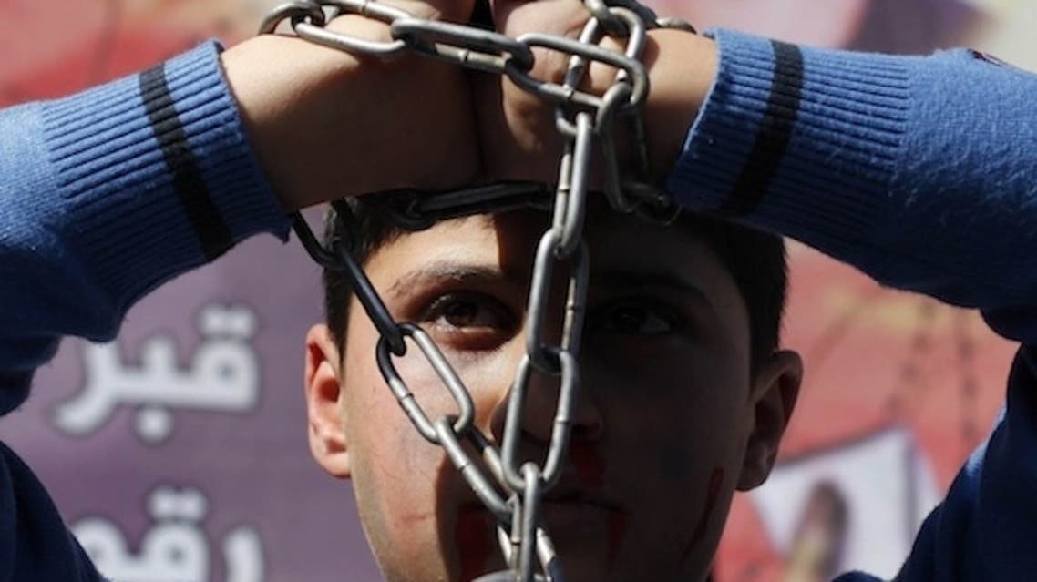 A Palestinian boy takes part in a rally to show solidarity with Palestinian prisoners on hunger strike in Israeli jails on Feb. 21. (Reuters)