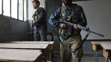 Syrian rebels take position inside a building to observe the movement of regime forces. (AFP)