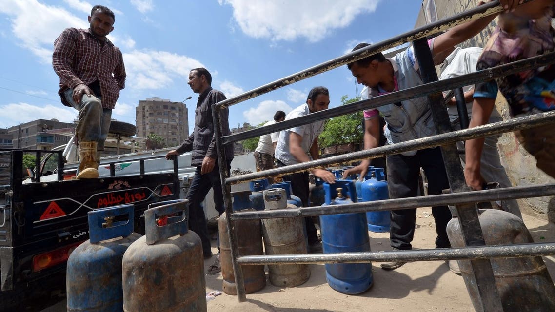 An Egyptian man loads gas cylinders onto a truck. Egypt hiked the price of subsidized cooking gas by 60 percent, triggering market chaos. (AFP)