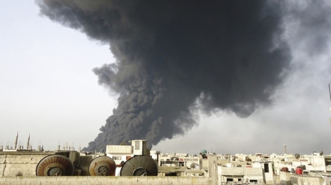 Black smoke is seen from Homs refinery. (Reuters)
