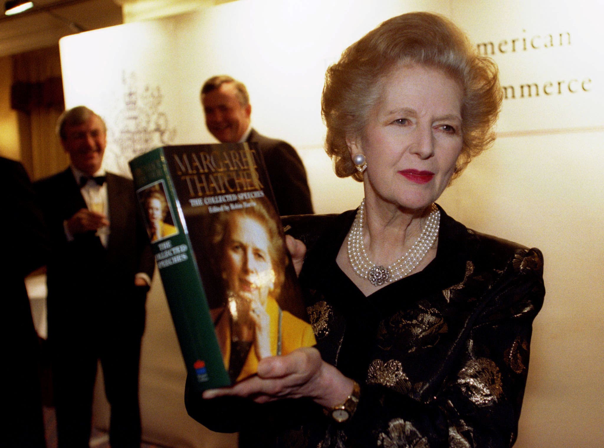 Baroness Margaret Thatcher poses with a copy of her new book at a launch attended by members of the British-American Chamber of Commerce in this November 25, 1997 file photo. (Reuters)