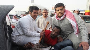 Police detain illegal African immigrants in Riyadh on March 10. Fearing roundups, many immigrants skipped work. (Reuters)