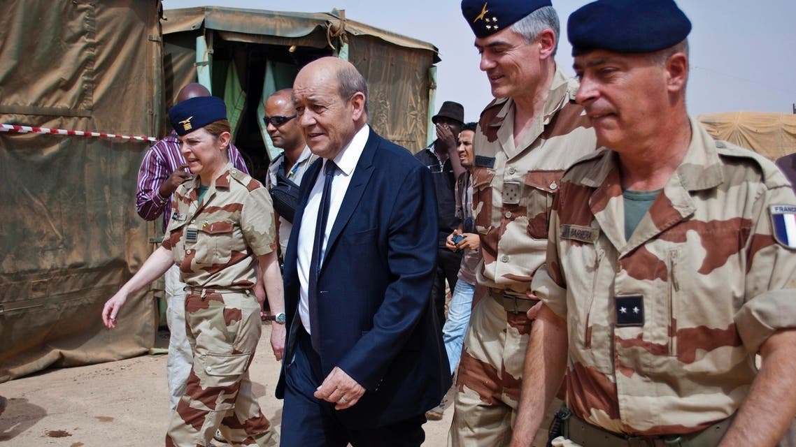 French Defence Minister Jean-Yves Le Drian (2nd L) arrives at the French military base at the airport in Gao April 26, 2013. (Reuters)