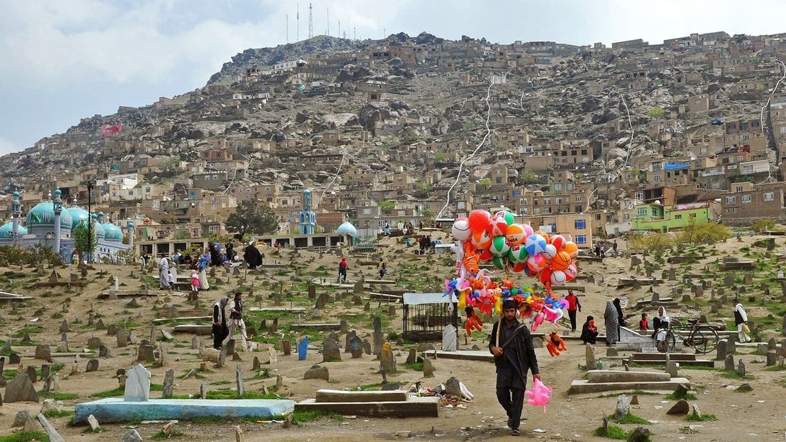 A street vendor sells balloons as he walks through the Karte Sakhi cemetary in Kabul. (AFP)
