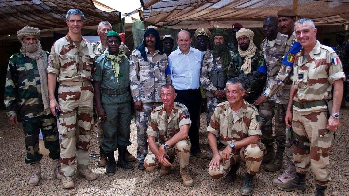 French Defence Minister Jean-Yves Le Drian (C) poses for a picture with French and Malian army officers at the French military base at the airport in Gao, April 26, 2013. (Reuters)