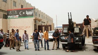 Libya militias pull guns from ministries, press protest