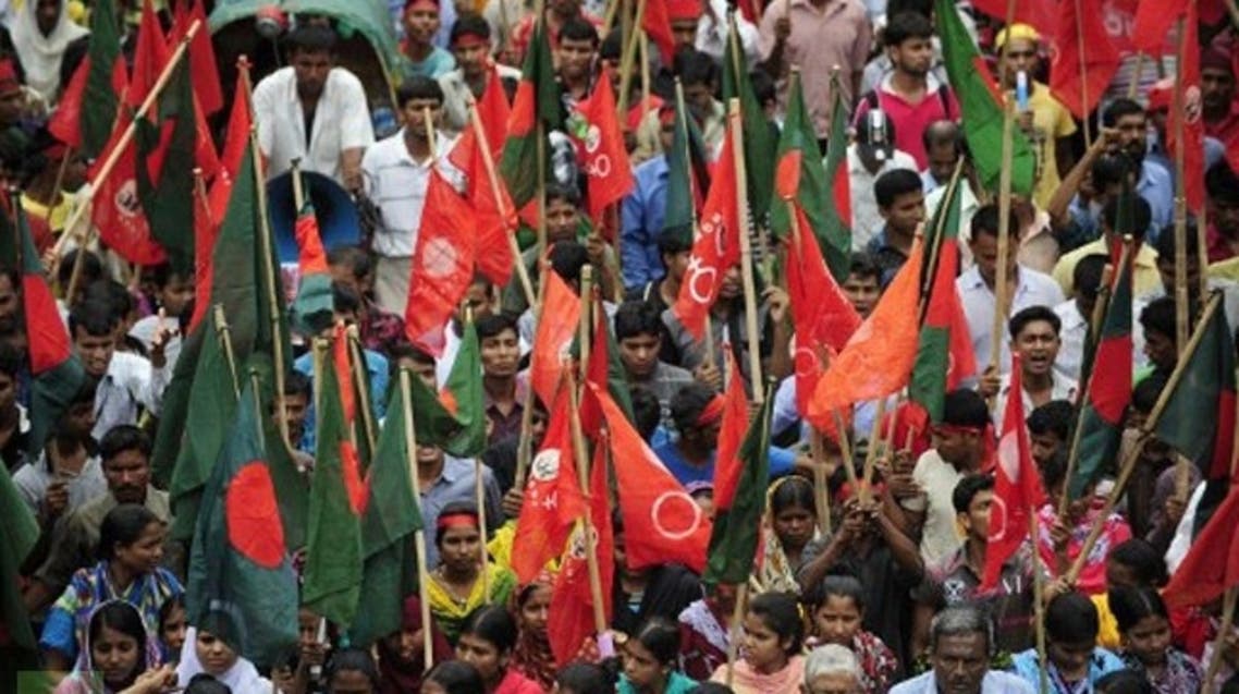 Bangladeshi activists shout slogans and wave flags during a procession to mark May Day in Dhaka. (AFP)