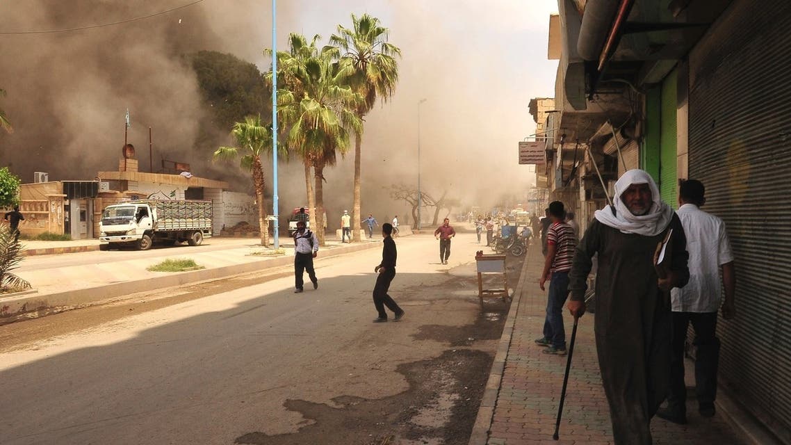 People run for cover after what activists said was shelling by forces loyal to Syria's President Bashar al-Assad in Raqqa province, eastern Syria May 3, 2013. (Reuters)