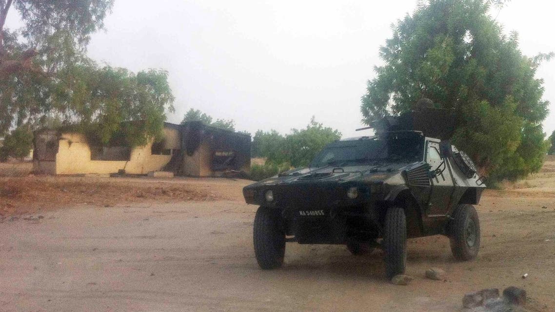 A military vehicle is seen in front of a burnt house in Bama, Maiduguri, Borno State, Nigeria. May 7, 2013. (REUTERS)