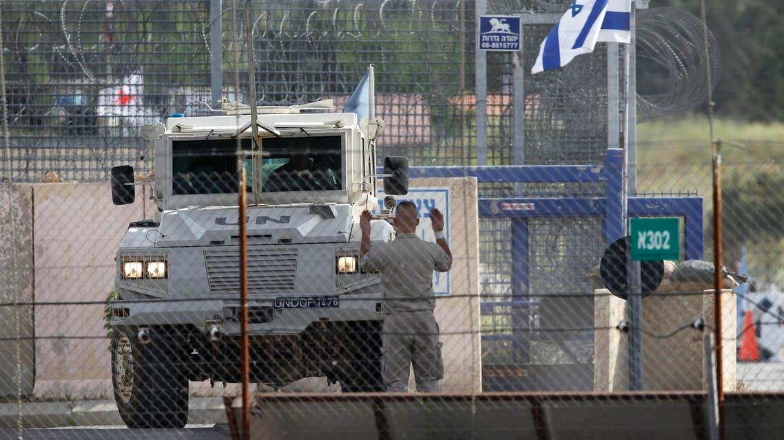 A United Nations peacekeeper directs an armoured vehicle after it crossed from Syria to the Israeli-occupied Golan Heights at the Kuneitra border crossing May 8, 2013.(reuters)