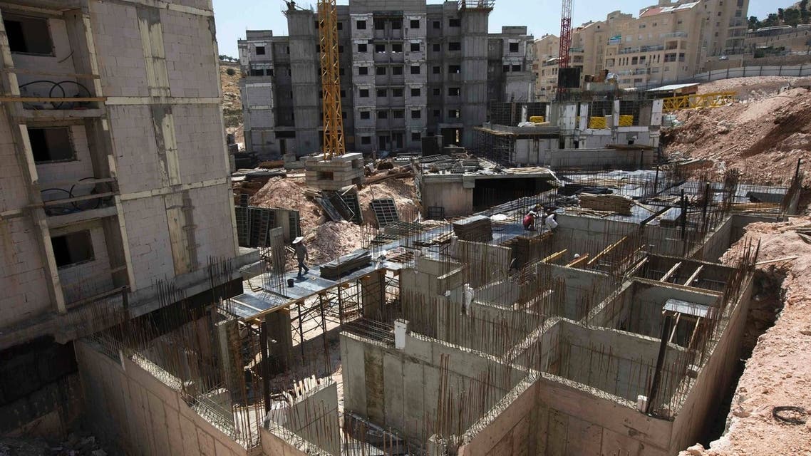 Labourers work on a construction site in a Jewish settlement near Jerusalem known to Israelis as Har Homa and to Palestinians as Jabal Abu Ghneim May 7, 2013. (Reuters)