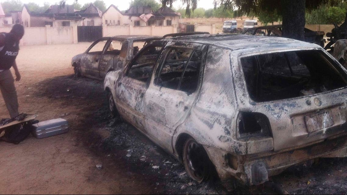A policeman inspects the site to collect evidence in Bama, Maiduguri, Borno State, Nigeria. May 7, 2013. (reuters)