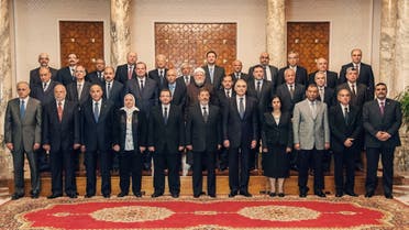 President Mohammed Mursi (centre) with Prime Minister Hisham Qandil and nine new cabinet ministers during a meeting in Cairo. (AFP)