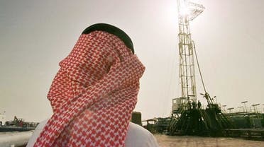 An official of the Saudi oil company Aramco watches progress at a rig at al-Howta oil field near Howta, Saudi Arabia. Picture: AP