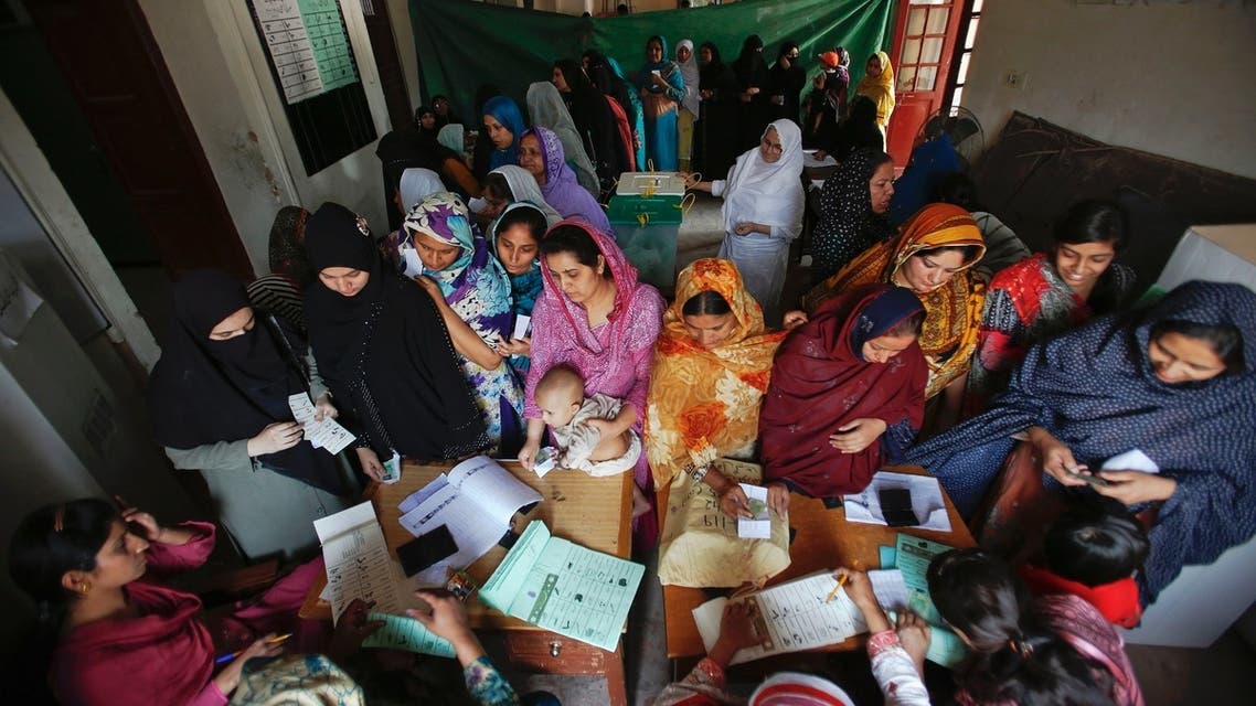 Women register and cast their ballots at a polling station in the old part of Lahore May 11, 2013. (Reuters)