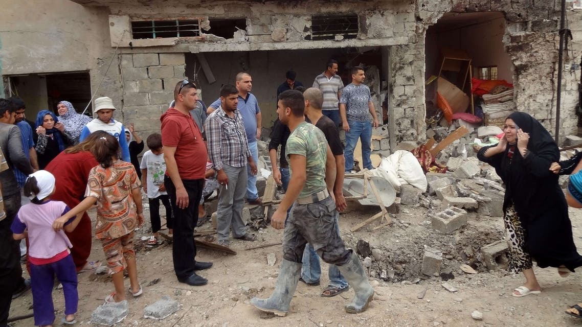 Iraqis gather at the site of a bombing in the northern city of Kirkuk on May 15, 2013. (AFP)