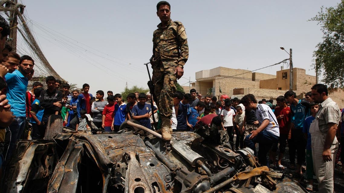 An Iraqi soldier steps over wreckage of a car bomb at the site of a car bomb attack in Baghdad's Sadr City May 16, 2013. (REUTERS)