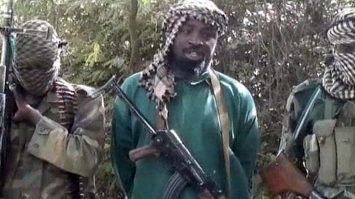 Abubakar Shekau (C), the suspected leader of Nigerian Islamist extremist group Boko Haram, flanked by two armed and hooded fighters in an undisclosed place. (AFP)