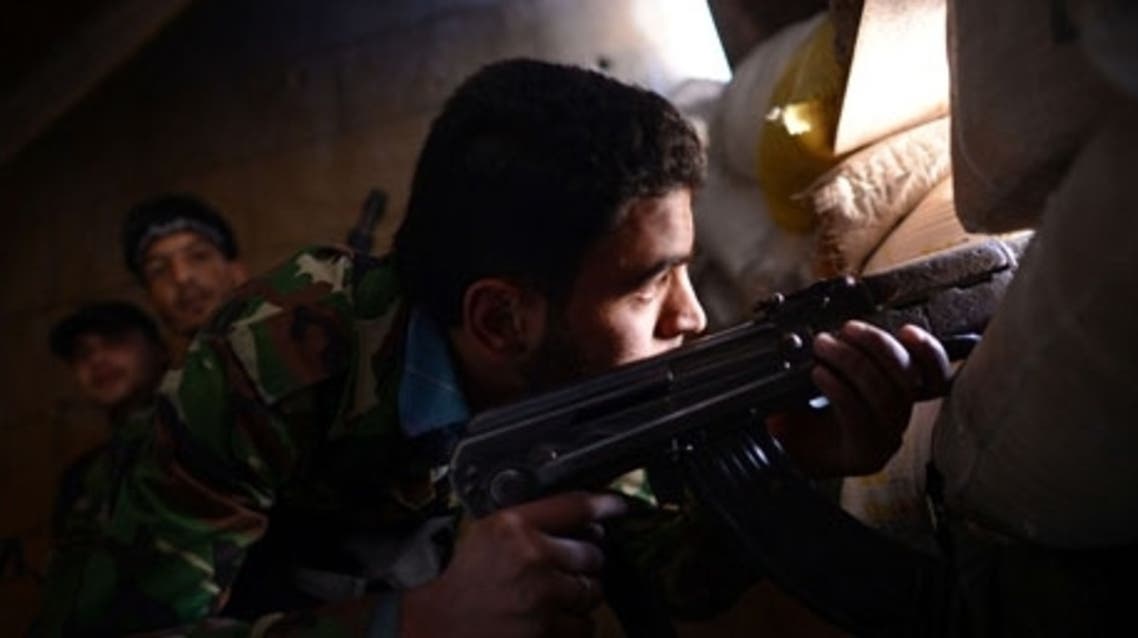 A Syrian rebel observes the positions of regime forces in Saif al-Dawla district in the northern city of Aleppo. (File photo: AFP)