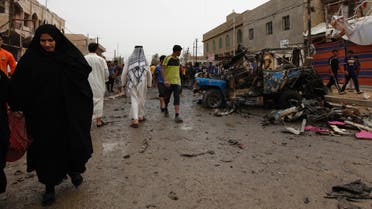 Residents gather at the site of a car bomb attack at the Kamaliya district in Baghdad May 20, 2013. (Reuters)