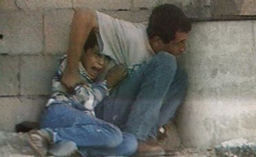 A TV grab from France 2 footage shot in 2000 in the Gaza Strip shows Jamal al-Dura and his son Mohammed. (AFP)