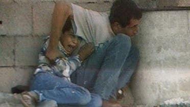 A TV grab from France 2 footage shot in 2000 in the Gaza Strip shows Jamal al-Dura and his son Mohammed. (AFP)