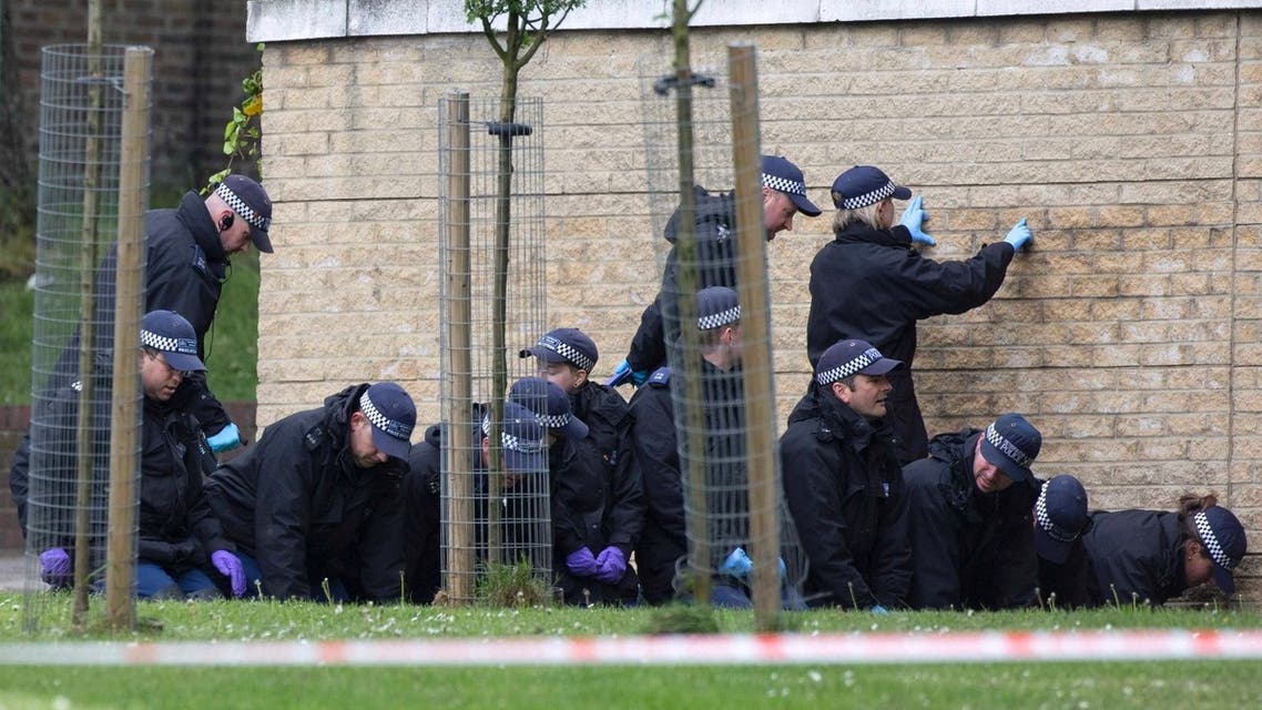 A police forensics team searches a crime scene for evidence, where a man was killed the day before in Woolwich, southeast London May 23, 2013. (Reuters)